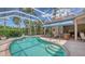 Screened-in pool area features a refreshing pool, a lounge area, and tropical landscaping for a relaxing outdoor experience at 5270 Far Oak Cir, Sarasota, FL 34238
