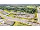 Scenic aerial view of a community clubhouse with a pool surrounded by lush landscaping, a golf course, and waterways at 5336 Grove Mill Loop, Lakewood Ranch, FL 34211