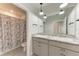 Clean bathroom with double sinks, granite countertops, and tiled floors at 5336 Grove Mill Loop, Lakewood Ranch, FL 34211