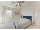 Bright bedroom showcasing neutral tones, plush carpeting, a bed, and a ceiling fan at 5336 Grove Mill Loop, Lakewood Ranch, FL 34211