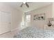 Bright bedroom featuring neutral colors, plush carpeting, and a ceiling fan at 5336 Grove Mill Loop, Lakewood Ranch, FL 34211