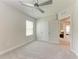 Bright bedroom featuring a ceiling fan, neutral walls, and plush carpeting at 5336 Grove Mill Loop, Lakewood Ranch, FL 34211