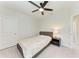 Bright bedroom with plush carpet, modern ceiling fan, and neutral decor at 5336 Grove Mill Loop, Lakewood Ranch, FL 34211