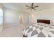 Spacious bedroom features a ceiling fan, carpet and large windows for natural light at 5336 Grove Mill Loop, Lakewood Ranch, FL 34211
