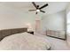 Cozy bedroom with soft carpet, stylish dresser, and modern ceiling fan at 5336 Grove Mill Loop, Lakewood Ranch, FL 34211