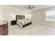 Spacious bedroom features a ceiling fan, carpet and large windows for natural light at 5336 Grove Mill Loop, Lakewood Ranch, FL 34211