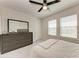 Bright bedroom featuring neutral colors, plush carpeting, and two windows at 5336 Grove Mill Loop, Lakewood Ranch, FL 34211