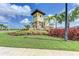 Attractive community entrance featuring decorative stonework and mature palms at 5336 Grove Mill Loop, Lakewood Ranch, FL 34211