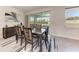 Bright dining room features a sliding glass door, stylish rug and contemporary decor at 5336 Grove Mill Loop, Lakewood Ranch, FL 34211
