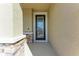 Close-up of a front door featuring decorative stone accents and a glass insert at 5336 Grove Mill Loop, Lakewood Ranch, FL 34211