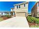Charming two-story home with neutral stucco and a well-manicured lawn and driveway at 5336 Grove Mill Loop, Lakewood Ranch, FL 34211