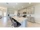 Spacious kitchen with gray cabinets, stainless appliances, and a large granite island with seating at 5336 Grove Mill Loop, Lakewood Ranch, FL 34211