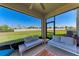 Spacious screened lanai with comfortable seating and serene backyard views at 5336 Grove Mill Loop, Lakewood Ranch, FL 34211