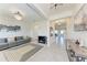 Open concept living area with tile flooring, modern lighting, and access to dining area at 5336 Grove Mill Loop, Lakewood Ranch, FL 34211