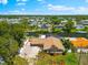 Charming waterfront home with lush landscaping, boat dock, and a screened-in lanai, perfect for outdoor living at 5563 America Dr, Sarasota, FL 34231