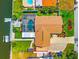 Aerial view of a waterfront home with a pool, dock, and lush landscaping, perfect for waterfront living at 5563 America Dr, Sarasota, FL 34231