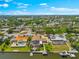 Beautiful waterfront homes featuring boat docks and backyard pools, nestled in a serene and lush neighborhood at 5563 America Dr, Sarasota, FL 34231