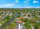 Charming neighborhood featuring waterfront homes along winding canals and waterways, nestled among lush green trees at 5563 America Dr, Sarasota, FL 34231