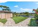 Picturesque waterfront view with a charming shed, lush lawn, and brick paver walkways at 5563 America Dr, Sarasota, FL 34231