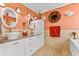 Bright bathroom with double sinks, tile floors, and unique decor at 5563 America Dr, Sarasota, FL 34231