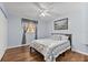 Comfortable bedroom featuring hardwood floors, a ceiling fan, and natural light at 5563 America Dr, Sarasota, FL 34231