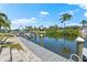 Picturesque waterfront view highlighting the community dock with lush greenery and serene waters at 5563 America Dr, Sarasota, FL 34231