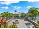 Stunning waterfront outdoor space with a cozy fire pit and beautifully landscaped surroundings at 5563 America Dr, Sarasota, FL 34231