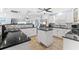 Bright kitchen with stainless steel appliances, granite countertops, tile backsplash, and central island at 5563 America Dr, Sarasota, FL 34231