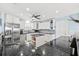 Spacious kitchen with white cabinets, stainless steel appliances, granite countertops, and central island at 5563 America Dr, Sarasota, FL 34231