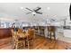 Large open-concept kitchen featuring hardwood floors, bar seating, and sight lines to the living room at 5563 America Dr, Sarasota, FL 34231