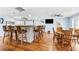 Open kitchen and dining area with bar seating, a dining table, and views of the living space at 5563 America Dr, Sarasota, FL 34231