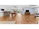 Large open living space with pool table, wet bar, hardwood floors, and a seamless flow at 5563 America Dr, Sarasota, FL 34231