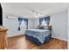 Comfortable bedroom with hardwood floors, two windows, and neutral paint at 5563 America Dr, Sarasota, FL 34231