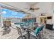 Charming covered patio with stylish outdoor dining set and views of the pool and backyard at 5563 America Dr, Sarasota, FL 34231