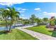 Scenic waterfront view of the private dock and boat lift from the lush green yard at 5563 America Dr, Sarasota, FL 34231