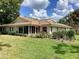 Spacious backyard featuring a screened in porch, lush landscaping, and room for outdoor entertaining at 5714 Garden Lakes Dr, Bradenton, FL 34203