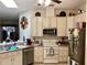 Well-lit kitchen featuring white cabinetry, stainless steel appliances, and efficient layout at 5714 Garden Lakes Dr, Bradenton, FL 34203