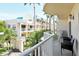 Inviting balcony view with tropical plants and palm trees, enhanced by elegant architecture at 5963 Midnight Pass Rd # 355, Sarasota, FL 34242