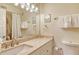 Well-lit bathroom featuring a granite countertop, decorative mirror, and modern towel racks at 5963 Midnight Pass Rd # 355, Sarasota, FL 34242