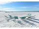 Beautiful beachfront featuring sugar sand and turquoise beach chairs to relax and enjoy at 5963 Midnight Pass Rd # 355, Sarasota, FL 34242
