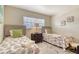 Bright bedroom with twin beds, accented by vibrant sea-themed bedding and a soft, neutral color palette at 5963 Midnight Pass Rd # 355, Sarasota, FL 34242