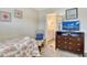 Cozy bedroom featuring a television, adjacent bathroom, accent chair, and relaxing, neutral tones at 5963 Midnight Pass Rd # 355, Sarasota, FL 34242