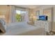 Bedroom with TV and balcony access at 5963 Midnight Pass Rd # 355, Sarasota, FL 34242