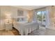 Bedroom with access to balcony and neutral decor at 5963 Midnight Pass Rd # 355, Sarasota, FL 34242