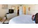 Cozy bedroom with a comfortable queen bed, a dresser, and an ensuite bathroom entrance at 5963 Midnight Pass Rd # 355, Sarasota, FL 34242