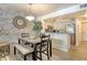 Dining room with wood flooring, stone accent wall, and a pendant light at 5963 Midnight Pass Rd # 355, Sarasota, FL 34242