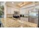 Kitchen with granite counters, stainless appliances, and white cabinetry offers great natural light at 5963 Midnight Pass Rd # 355, Sarasota, FL 34242