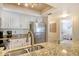 Modern kitchen features white cabinets, stainless steel appliances, and granite countertops at 5963 Midnight Pass Rd # 355, Sarasota, FL 34242