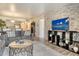 Open concept living and dining area with modern decor and brick accent wall at 5963 Midnight Pass Rd # 355, Sarasota, FL 34242