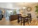 Living room with wood flooring, sofa, stone accent wall, and sliding glass door to outside balcony at 5963 Midnight Pass Rd # 355, Sarasota, FL 34242